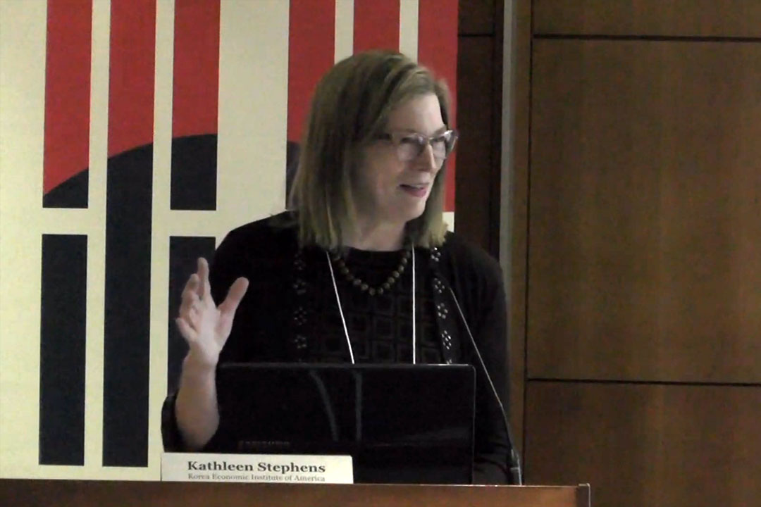 Speaker stands at the podium