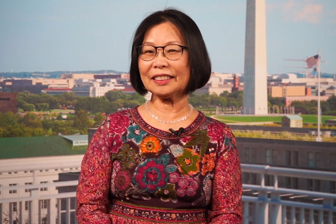 Young-Key Kim-Renaud speaking with the Washington Monument in the background